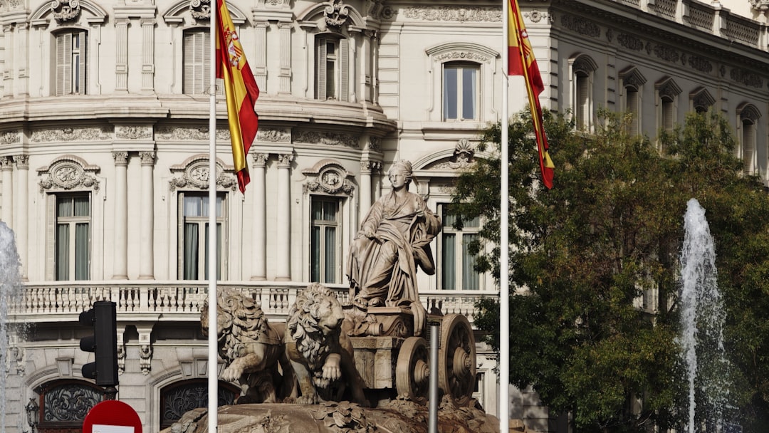 Statue of goddess cibeles with spanish flags and fountains